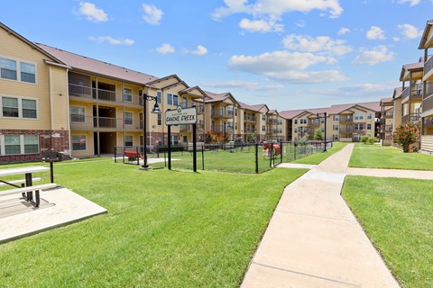 A sunny day at the Cannine Greets apartment complex with a clear blue sky.