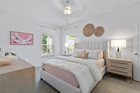 a bedroom with a bed and a chair and a window