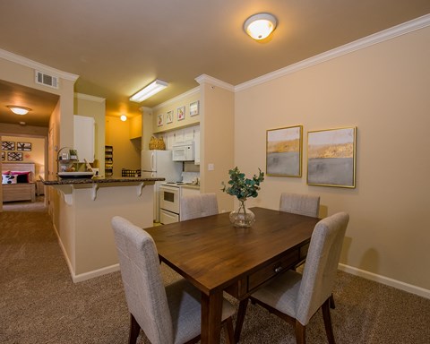 A dining room with a table and chairs.