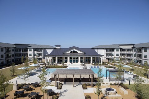 an aerial view of an apartment complex with a swimming pool