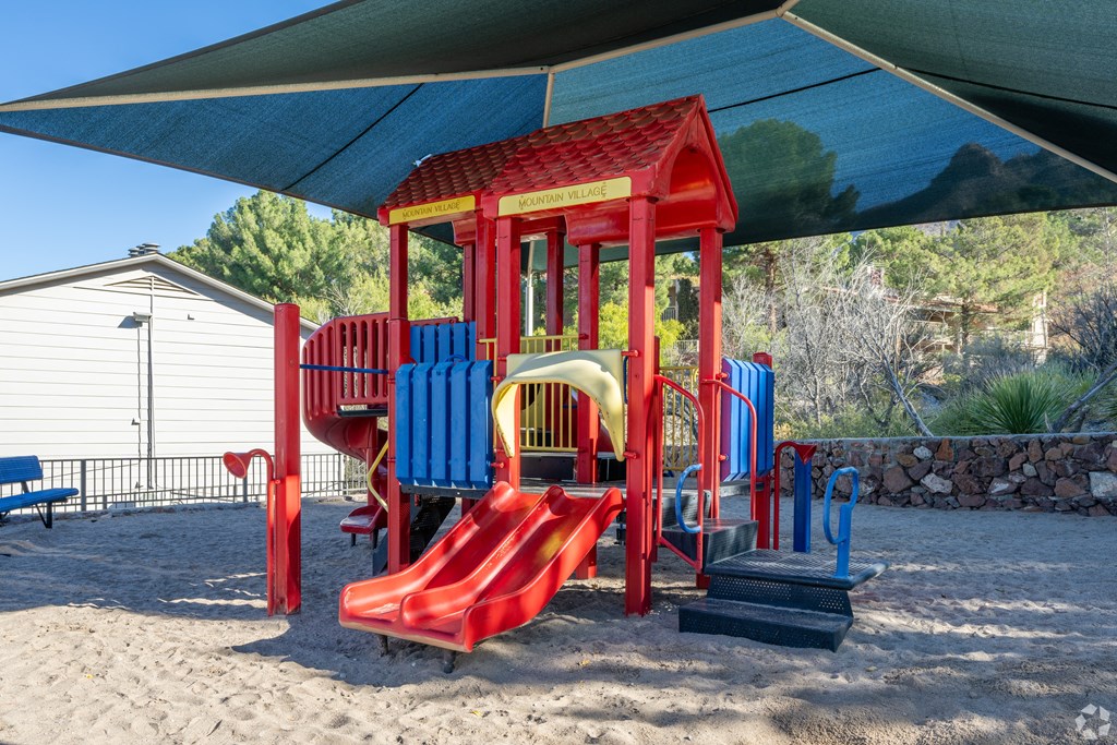 A red and blue playground structure with a red slide.