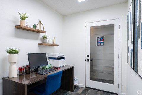 A small office with a desk, chair, and a laptop.