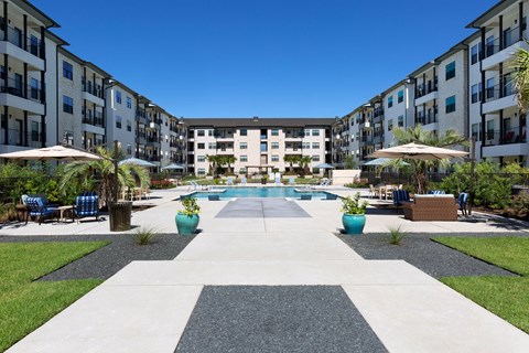 an outdoor courtyard with a pool and apartment buildings