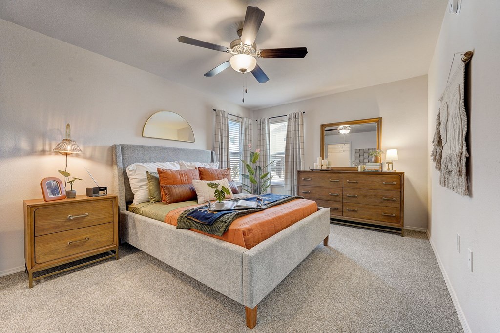 a bedroom with a bed and a ceiling fan