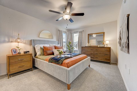 a bedroom with a bed and a ceiling fan