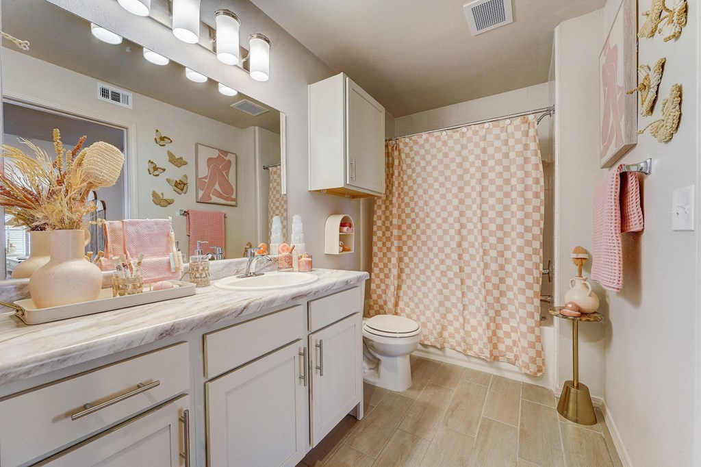 a bathroom with a shower and a sink and a toilet