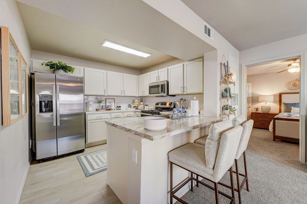 a kitchen with stainless steel appliances and a marble counter top