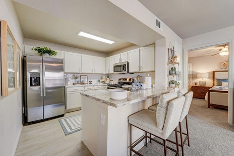 a kitchen with stainless steel appliances and a marble counter top