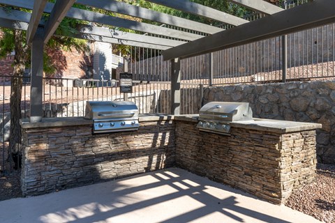 A stone wall with a grill on top.
