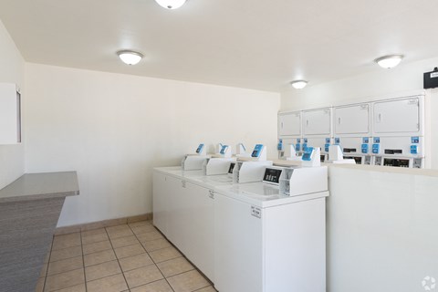 A laundromat with a row of washing machines.