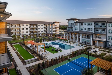 a rendering of an apartment complex with a pool and tennis court