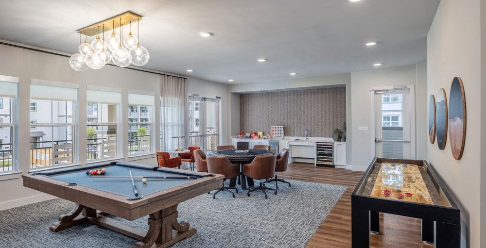 a gathering room with a pool table and a bar