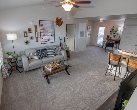 A living room with a grey couch and a coffee table.