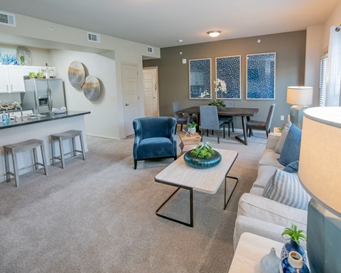 A living room with a blue couch and a coffee table.