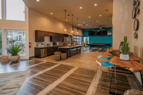 A modern kitchen with a dining table and chairs.
