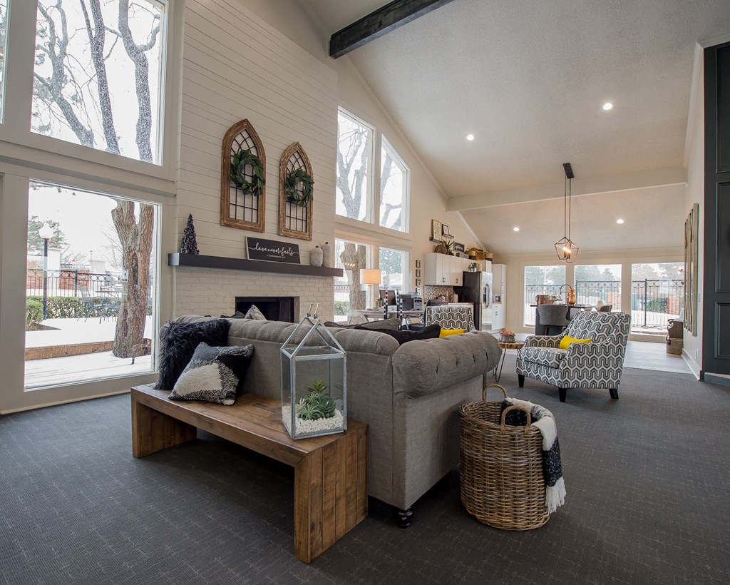 A living room with a grey couch and a wooden bench.