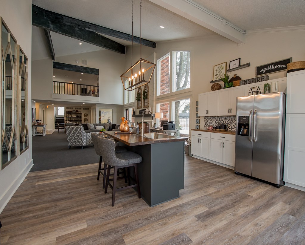 A kitchen with a wooden floor and a large island in the middle.