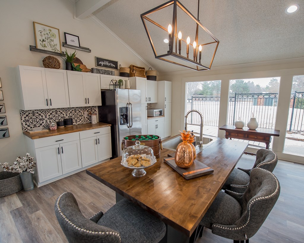 A dining room with a wooden table and chairs.