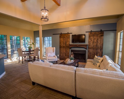 A living room with a white couch and a fireplace.