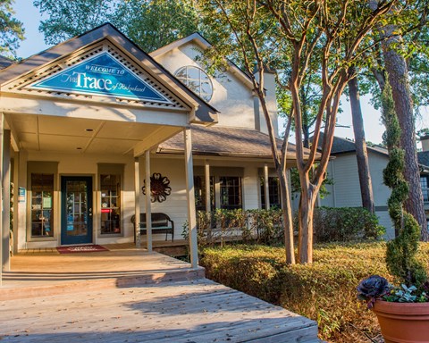A house with a porch and a sign that says "Trace".