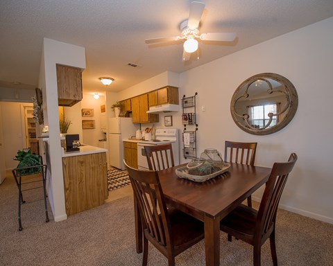A dining room with a table set for two.