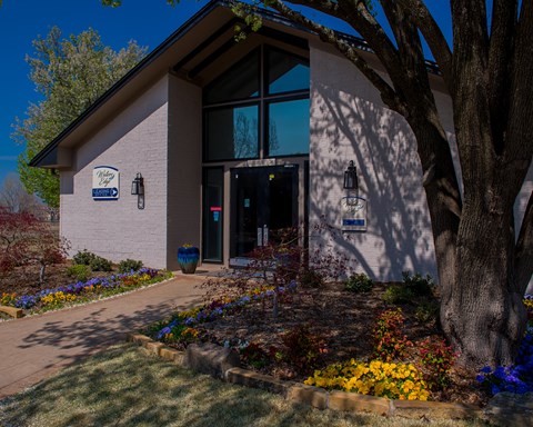 A building with a garden in front of it.
