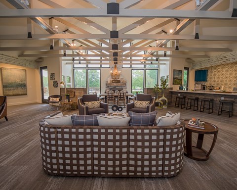 A living room with a large sofa and a coffee table.