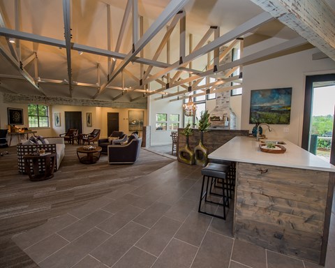 A large open space with a kitchen island and a dining area.