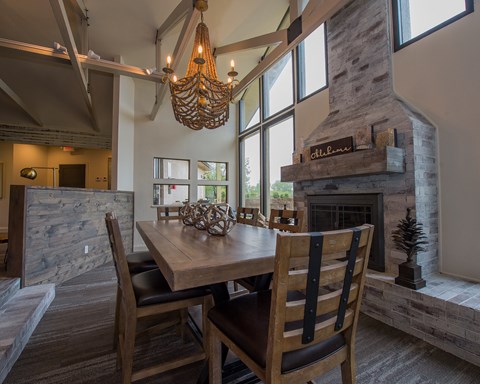 A dining room with a wooden table and chairs.
