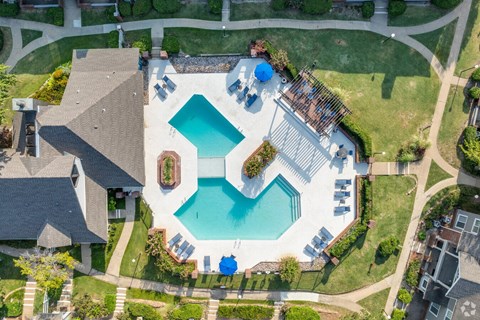 An aerial view of a house with a pool and a hot tub.