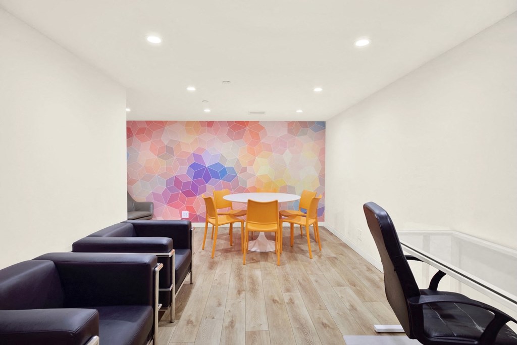 Meeting room with a colorful wallpaper and a table with chairs. at Midvale Court, Los Angeles