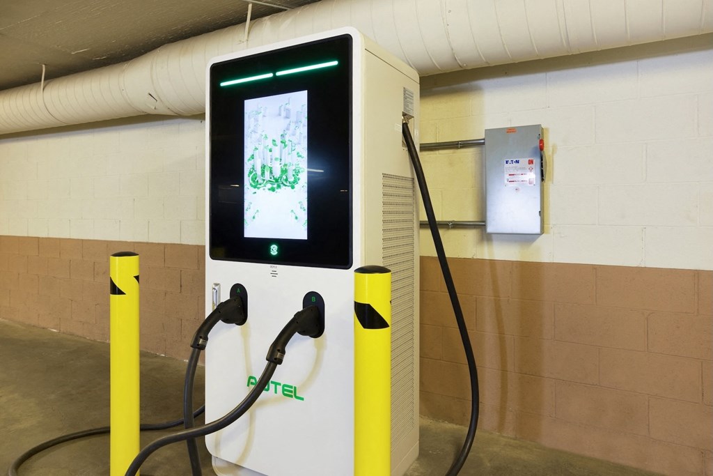 A charging station for electric vehicles is shown with a digital display. at Midvale Court, Los Angeles