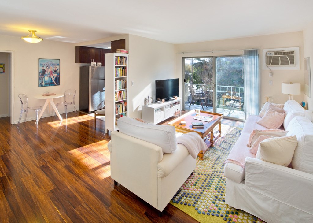 Apartment living room with private balcony and kitchen