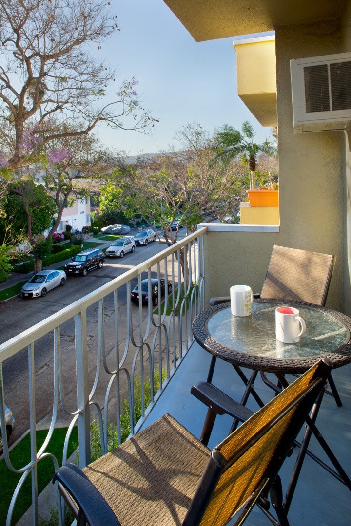 Apartment balcony with street and treetop views