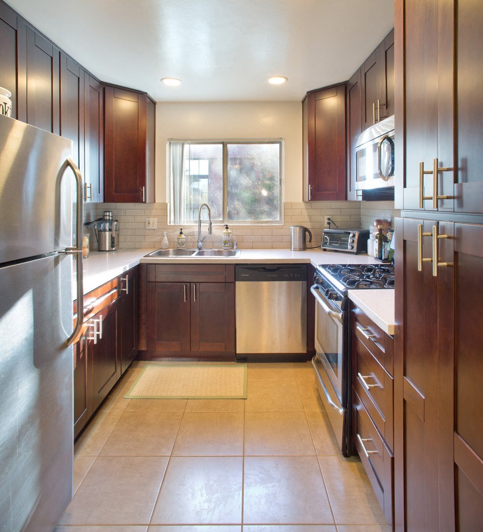 Apartment kitchen with stainless steel appliances and built-in cabinets