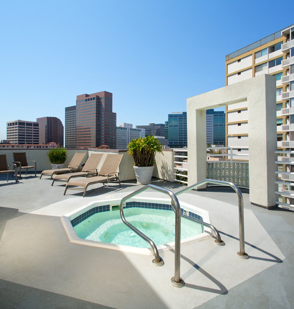 Roof terrace with hot tub, lounge furniture and city views