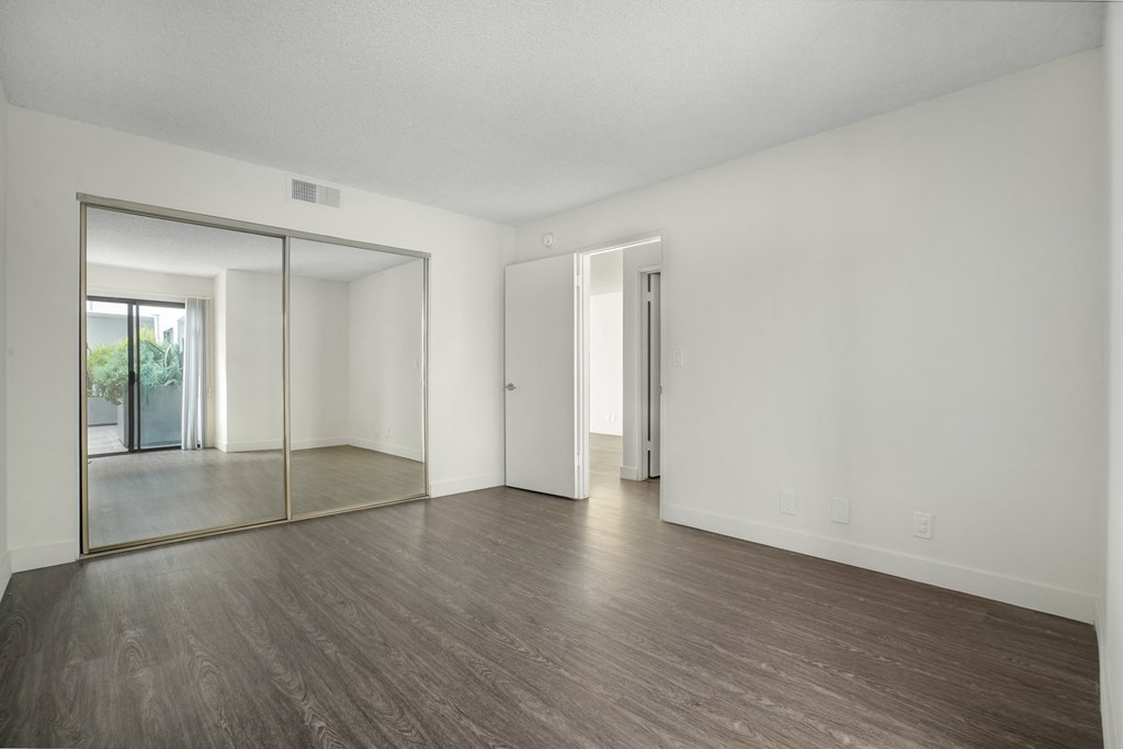 Apartment bedroom with mirrored closet doors