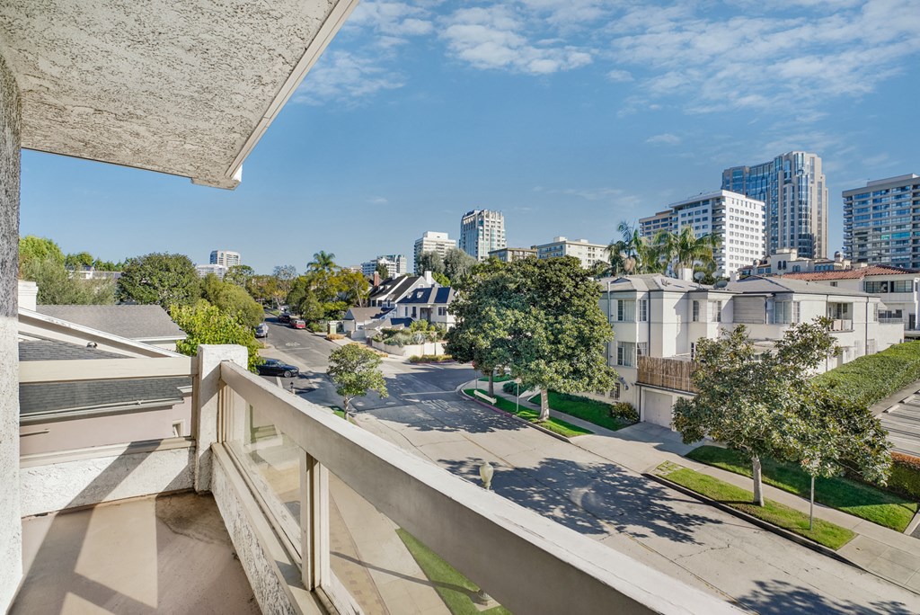 Apartment balcony with street and treetop views