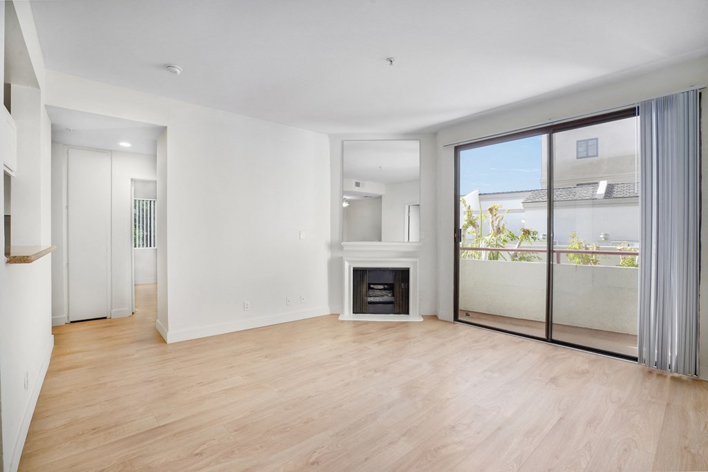 Apartment living room with fireplace and balcony. at Ashton Towers, Los Angeles, CA