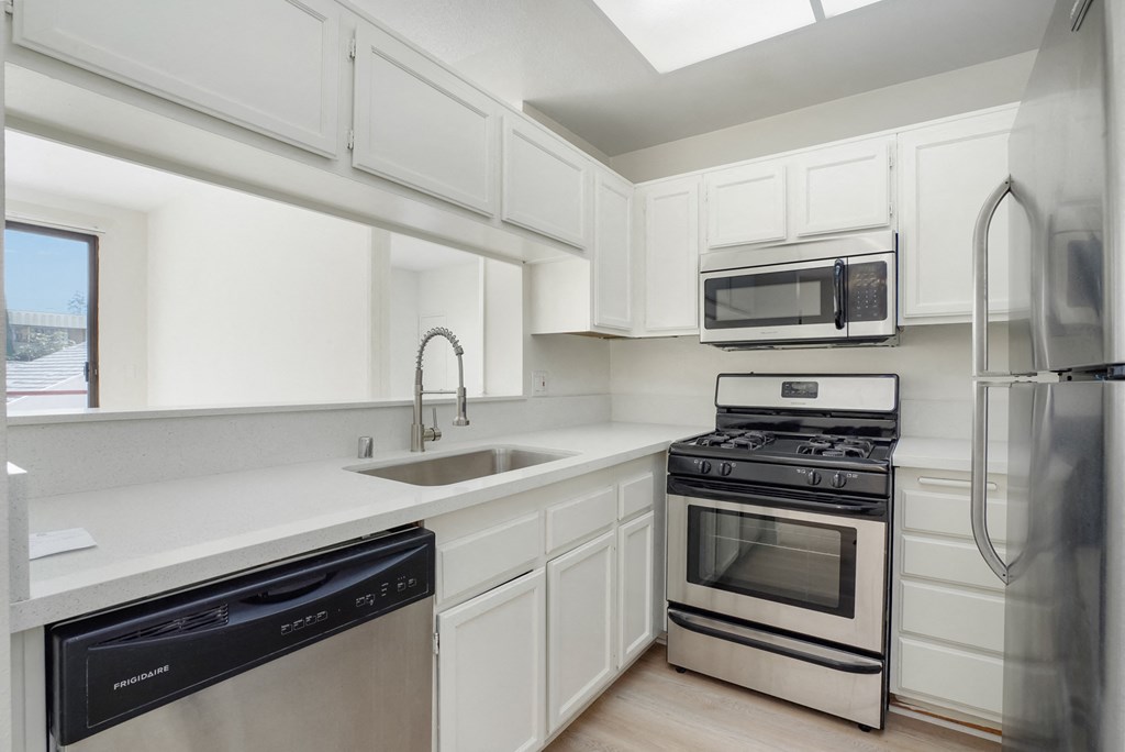 kitchen with stainless steel appliances, white counter tops and cabinets. at Ashton Towers, Los Angeles, 90024