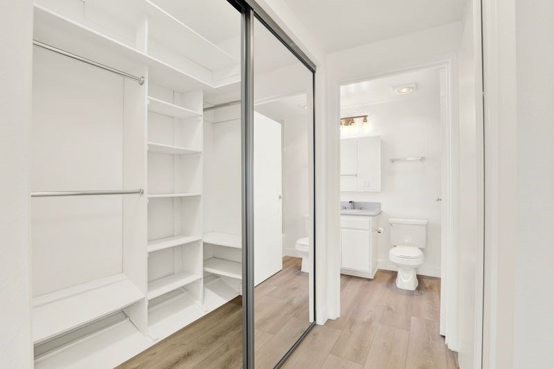 A white bathroom with a walk-in shower and a toilet.
