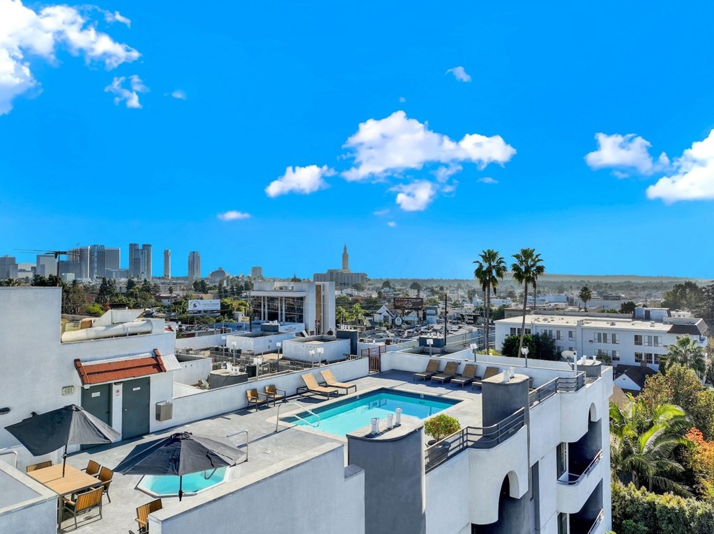 A rooftop pool area with a view of the city skyline at Midvale Court, Los Angeles
