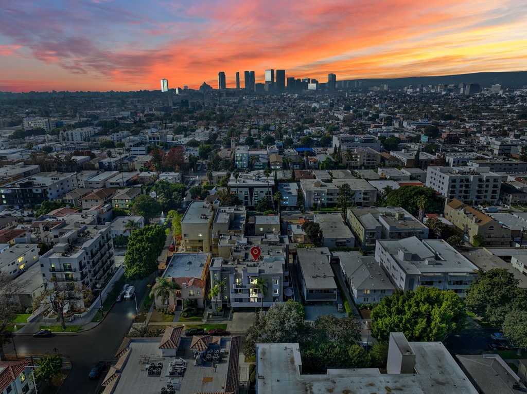 A cityscape with buildings and a sunset in the background.