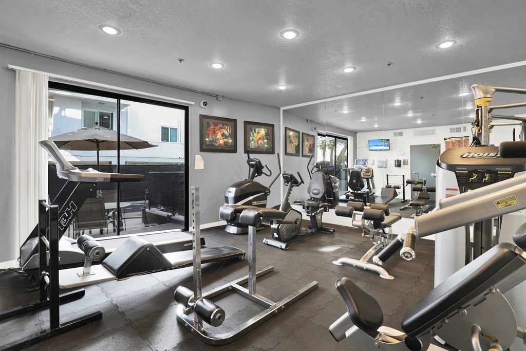 A gym with a variety of equipment and cardio machines at Park Rochester, Los Angeles