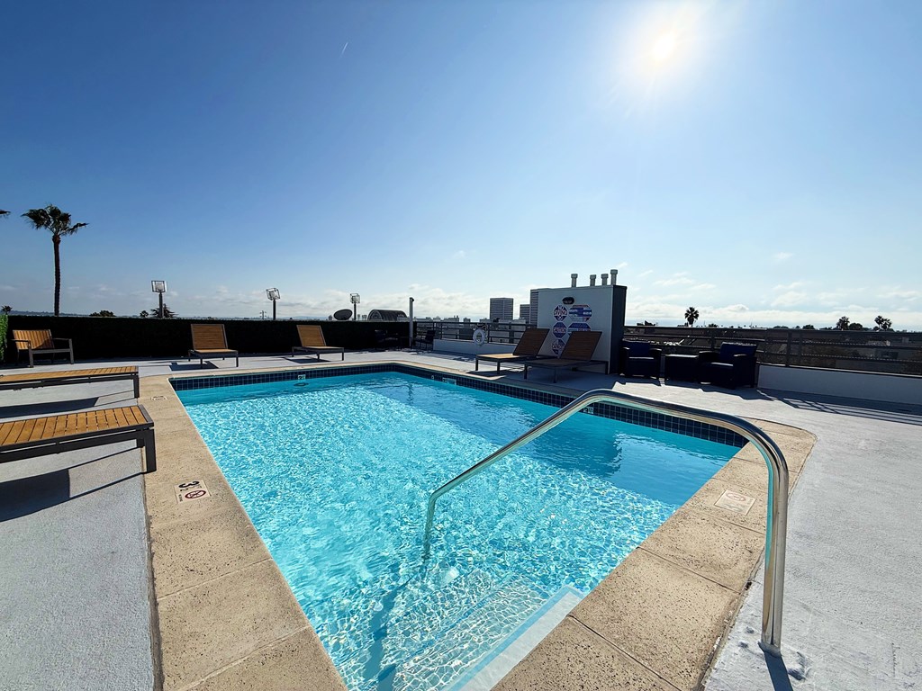 Swimming pool with a sunny sky in the background.