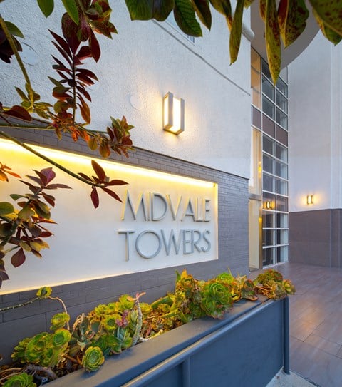 a sign in front of a building that reads midvale towers