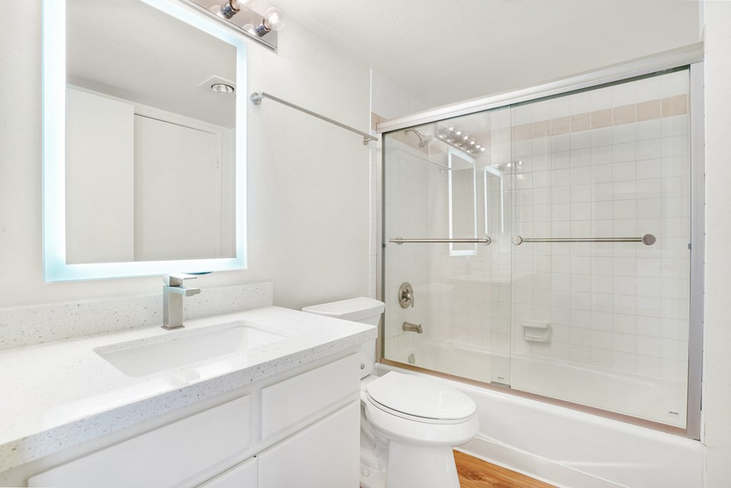 a bathroom with a shower and a sink and a toilet