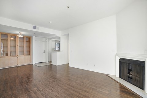 a living room with a fireplace and a wooden floor