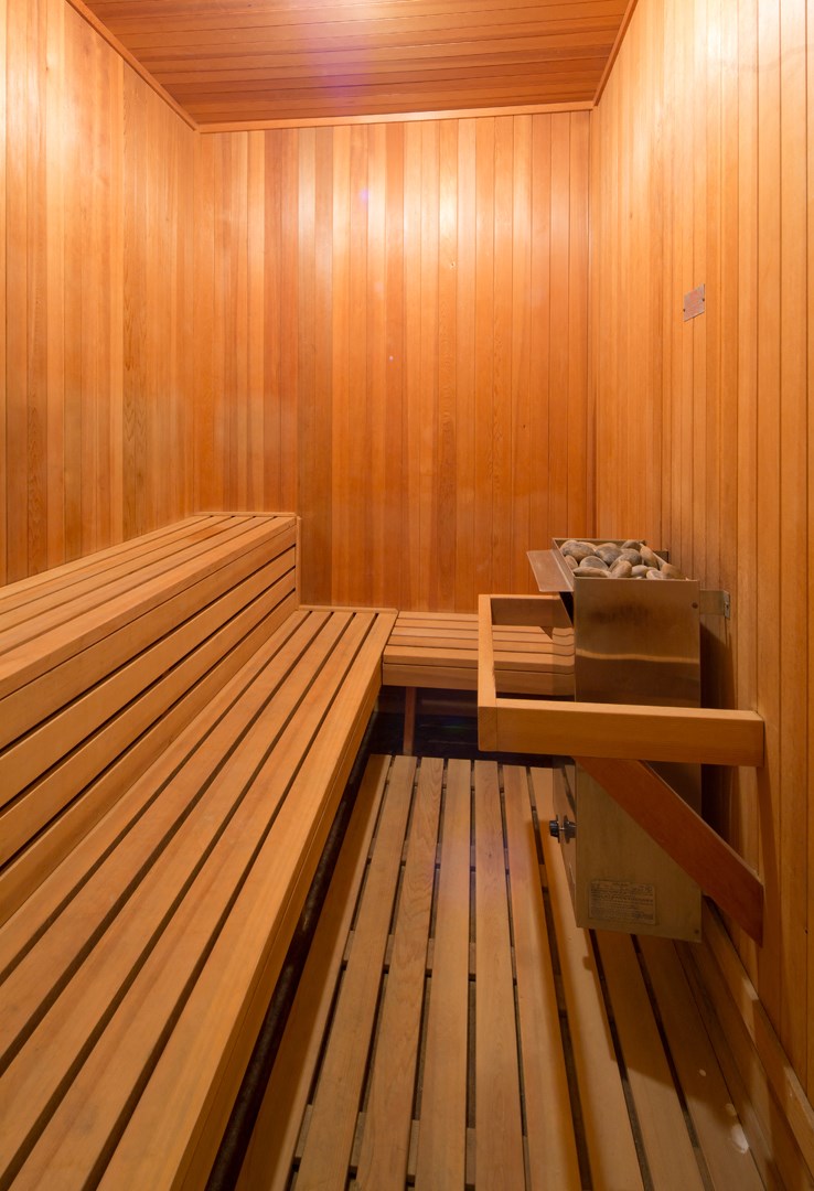 a sauna room with a wooden bench and a table