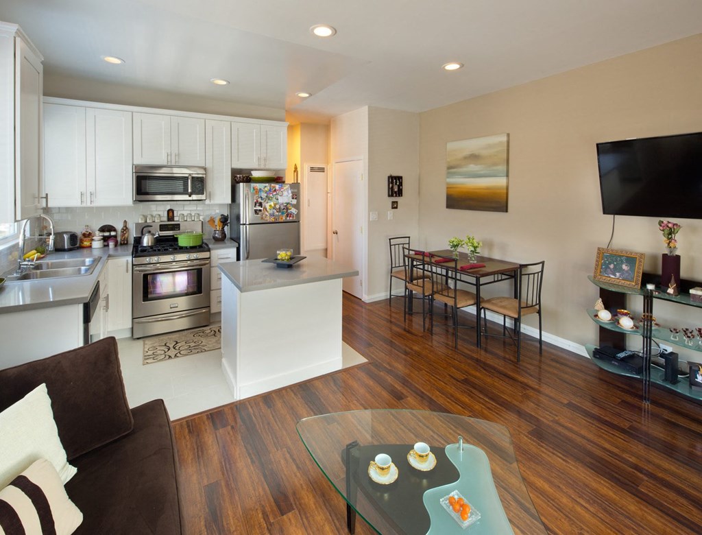 Apartment living room with kitchen and stainless steel appliances